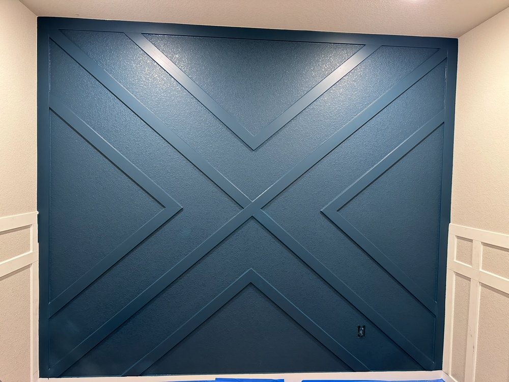 Bold navy accent wall with custom woodwork by M-G Painting